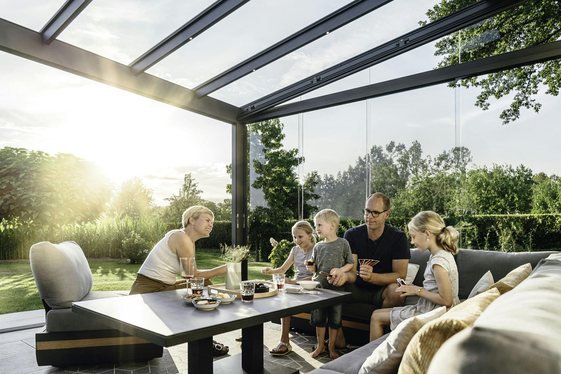 a family enjoying a meal in a Solarlux glass room