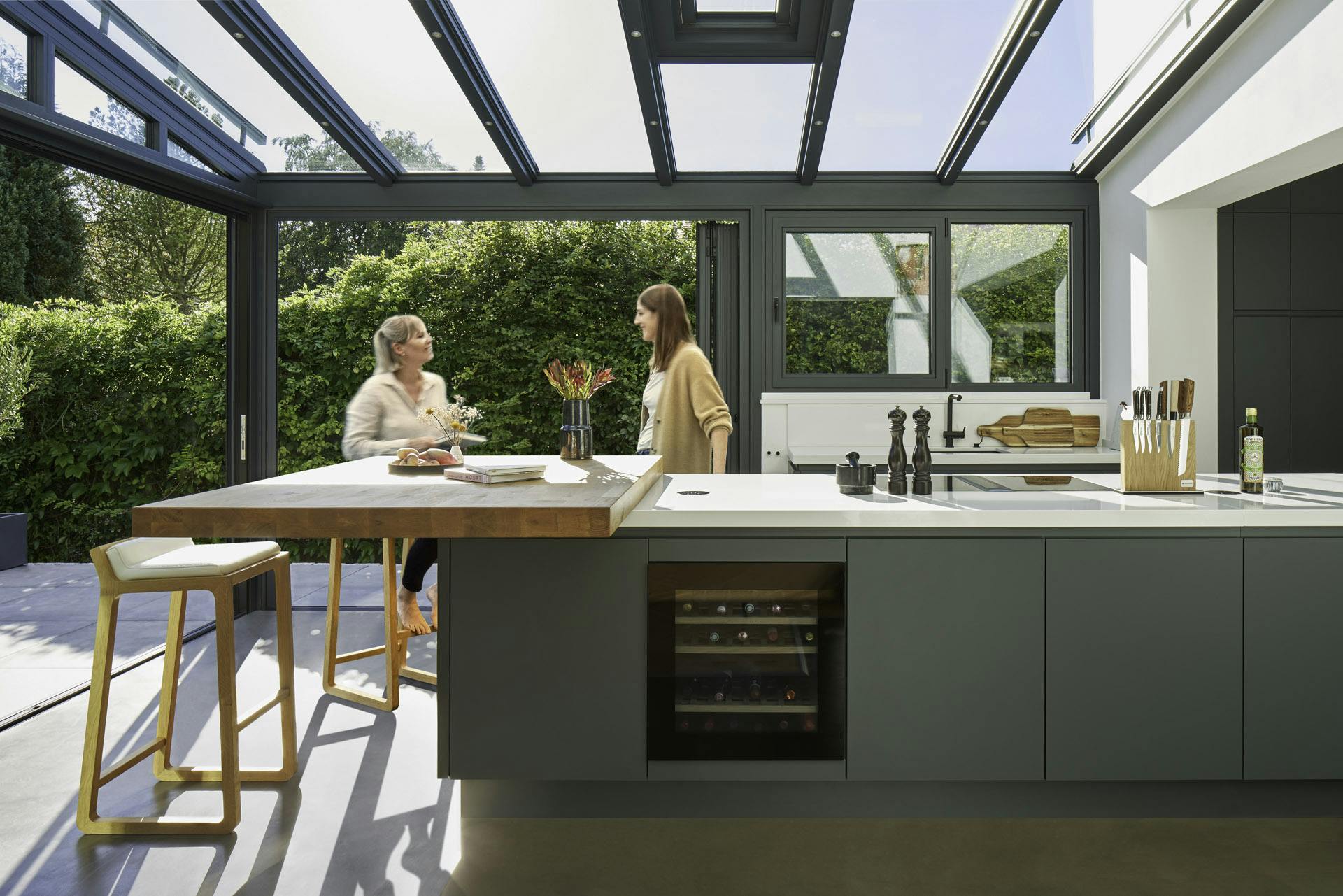 glass kitchen extension with friends chattting