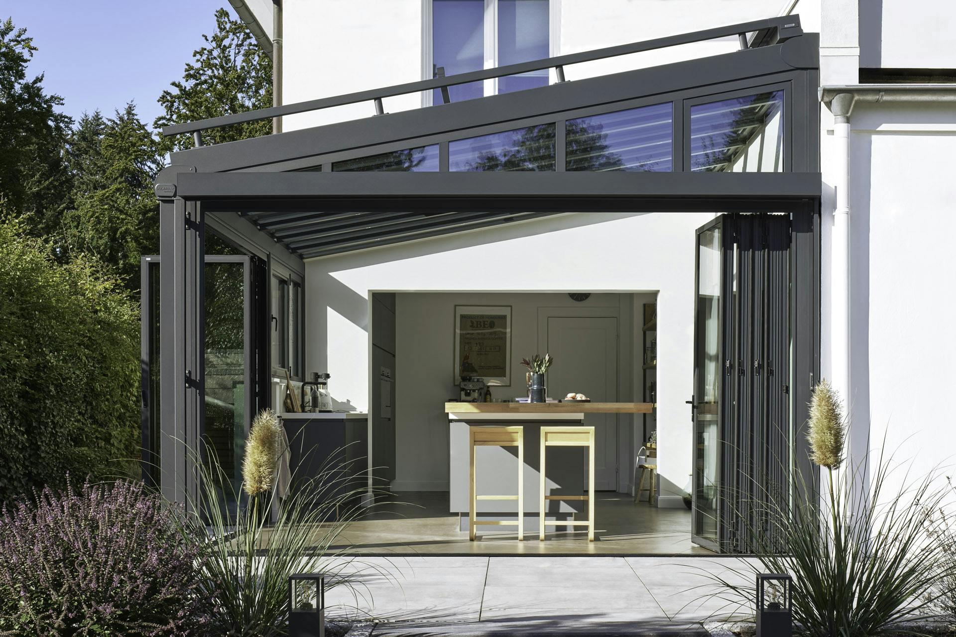 energy efficient glass kitchen conservatory with open doors in summer