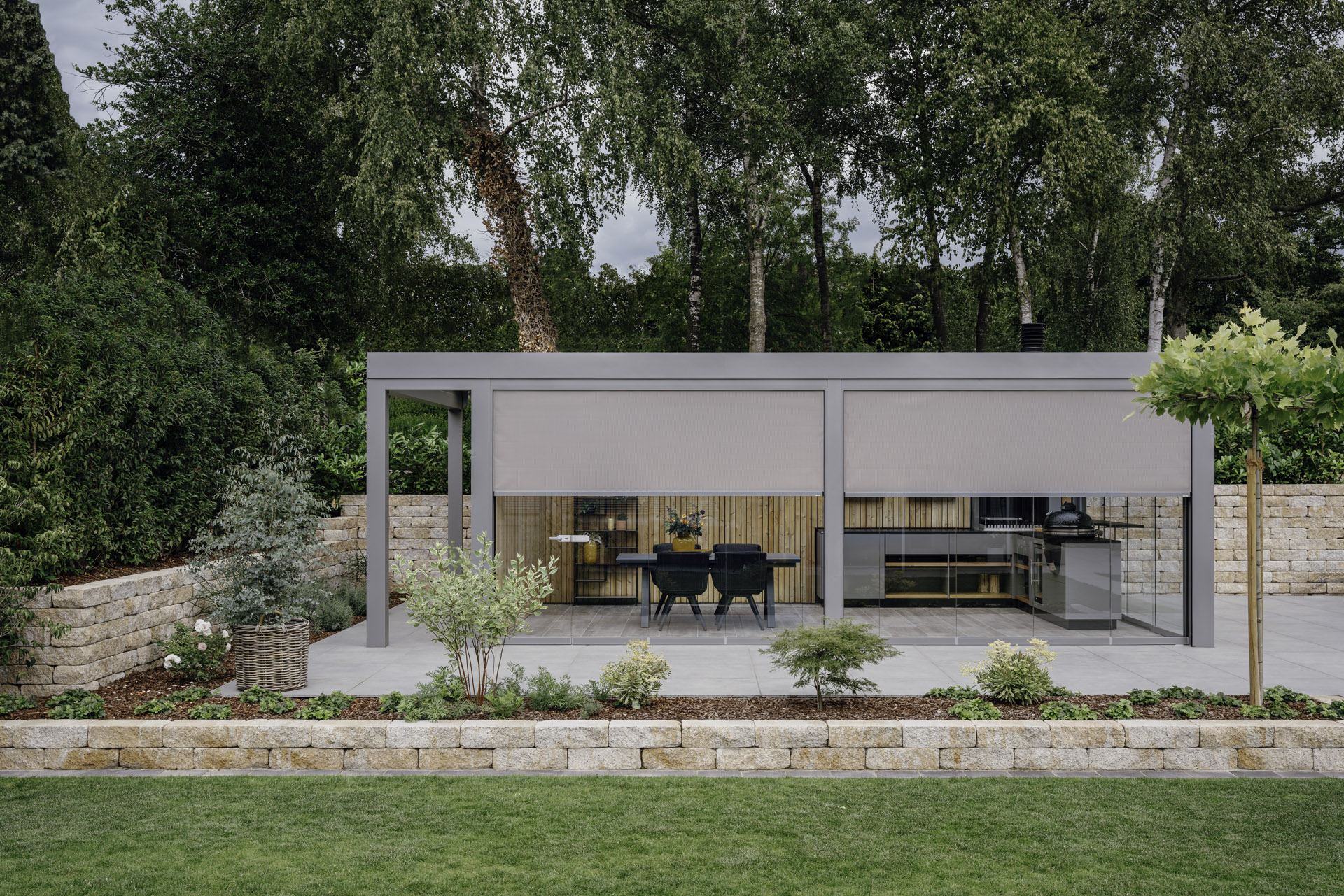 Glass Room with blinds half open in manicured garden