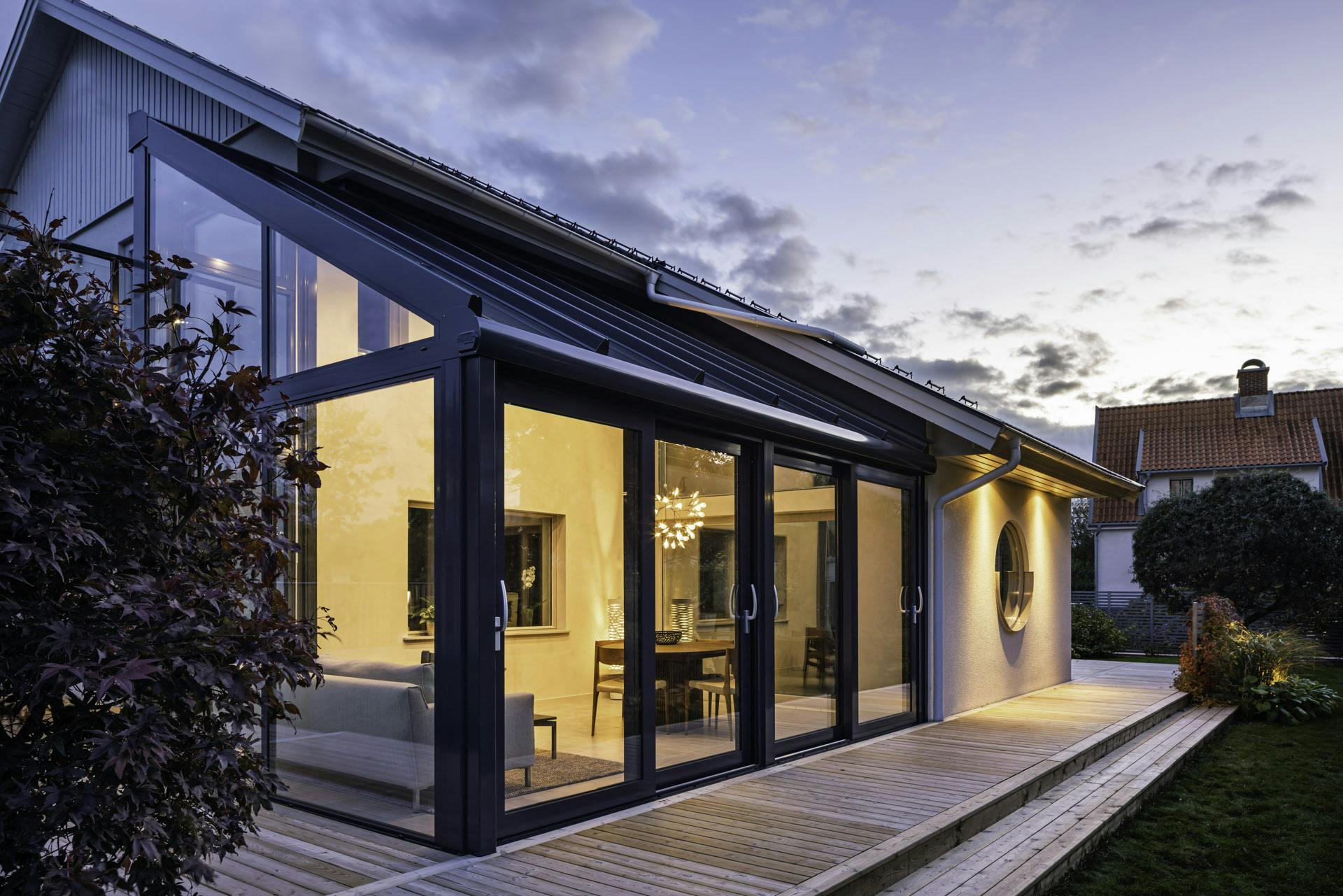 Luxury glass extension at night time pictured from outside