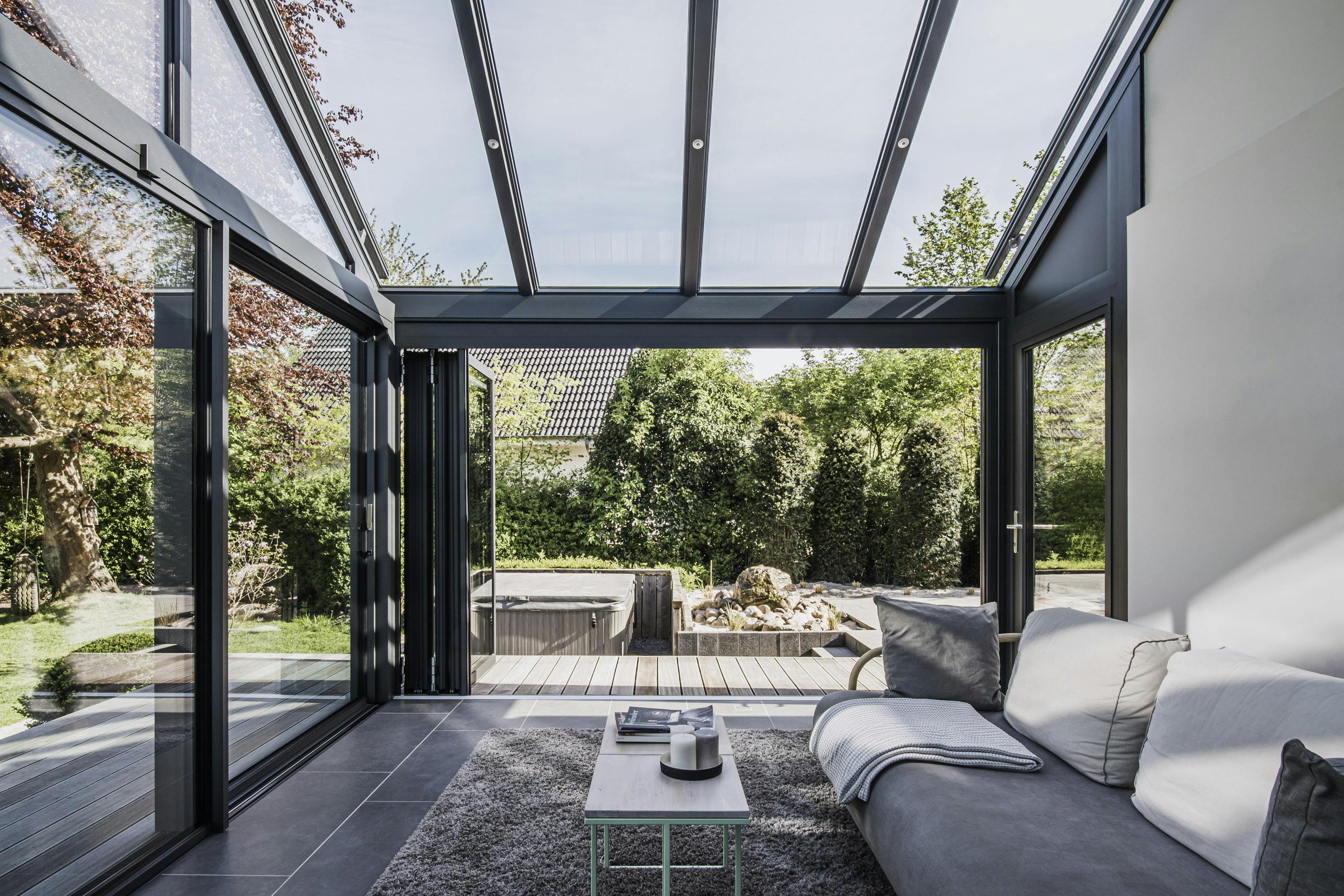 Glass home extension flooded with natural light on summers day