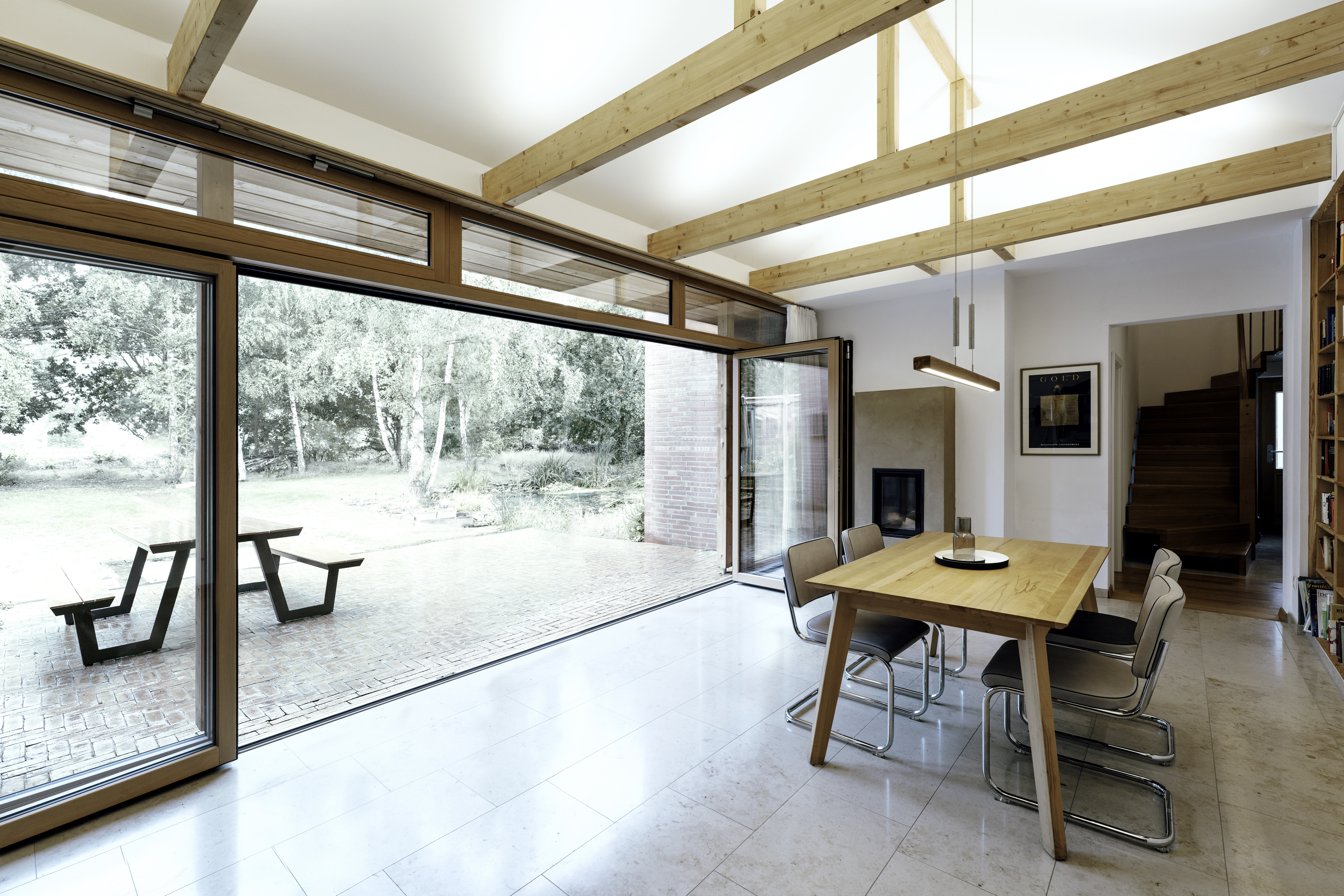 luxury wood bifolding doors in family dining kitchen