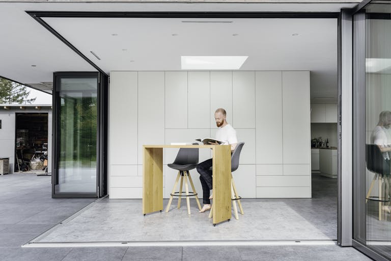 Open bi-folds with a man sitting indoors