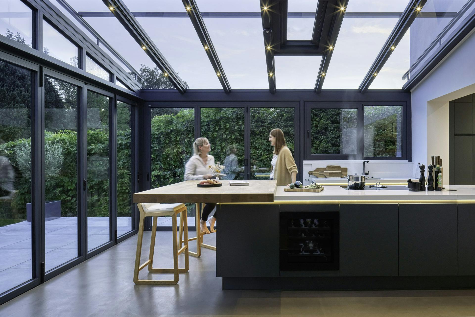 Glass Kitchen Extension interior with two women chatting