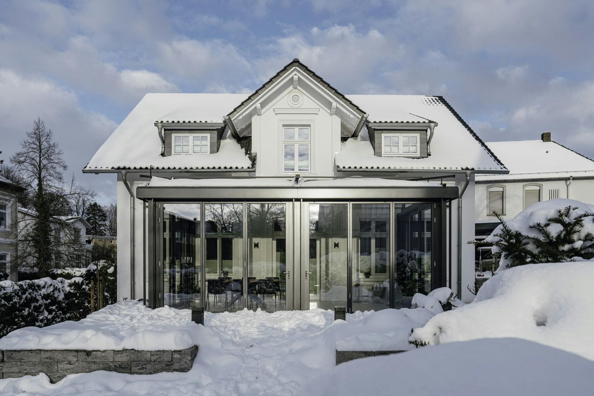 warm fully glazed orangery covered in snow