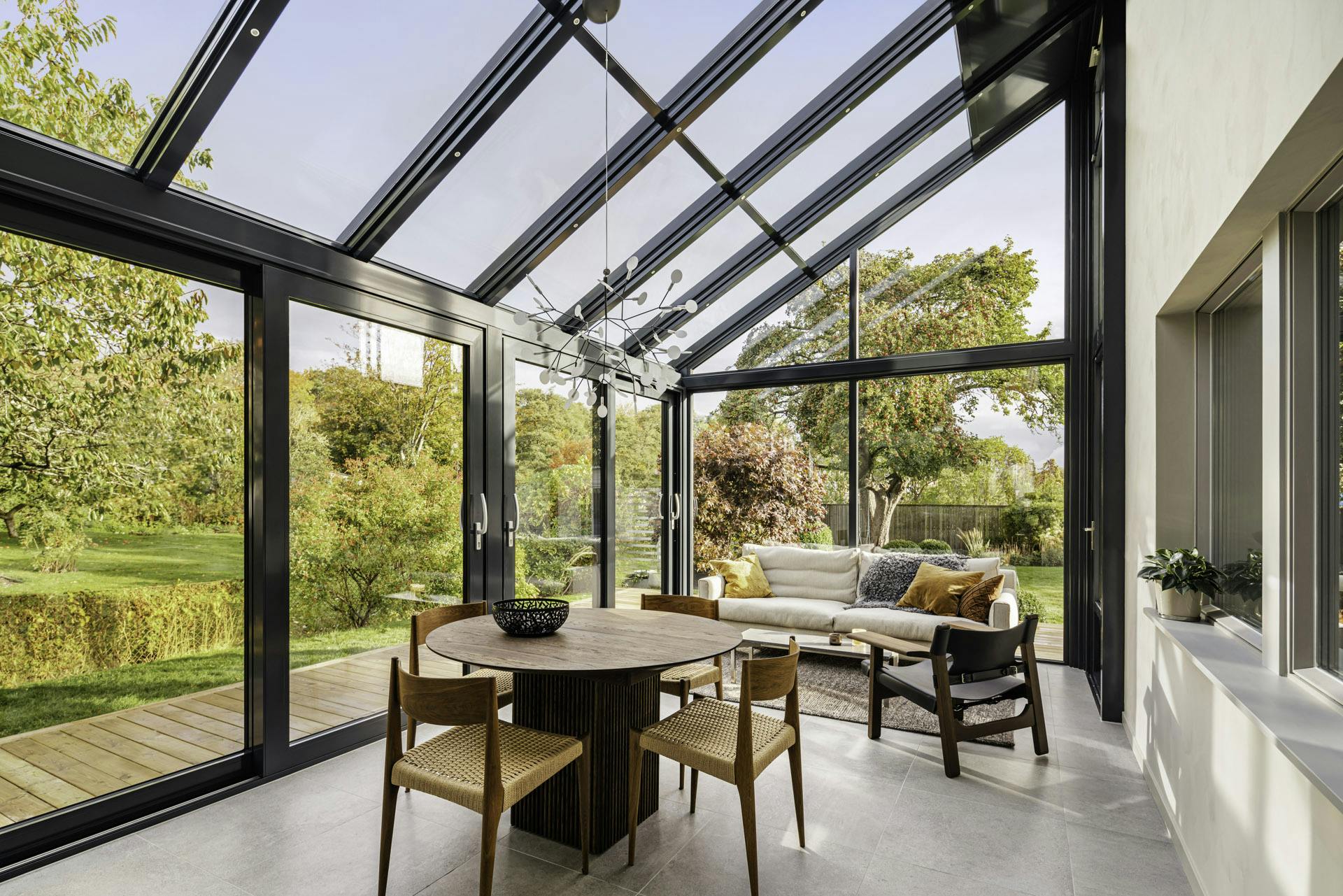 glass roof orangery with sofa table and chairs
