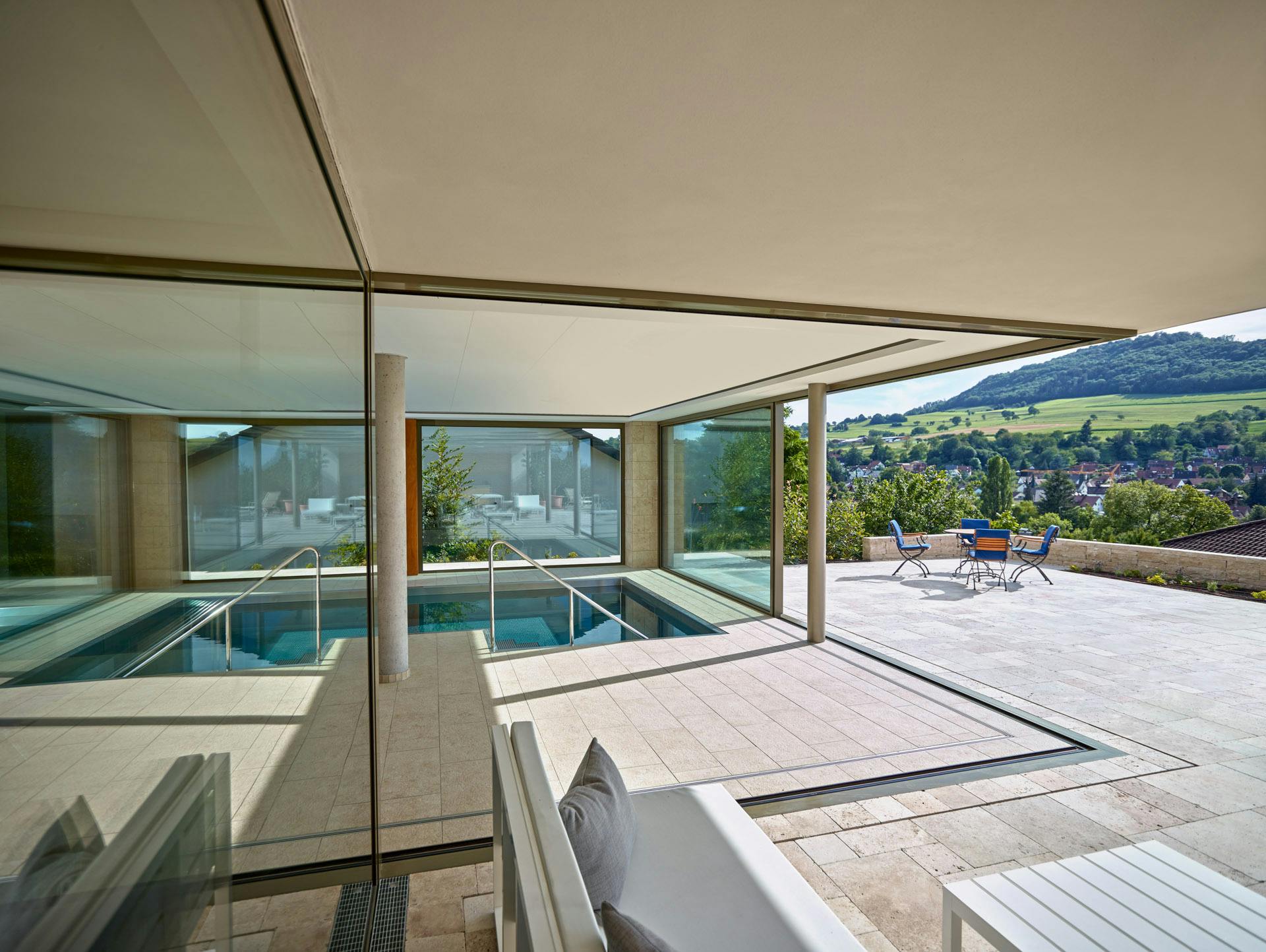 siding glass doors with cantilever roof and swimming pool