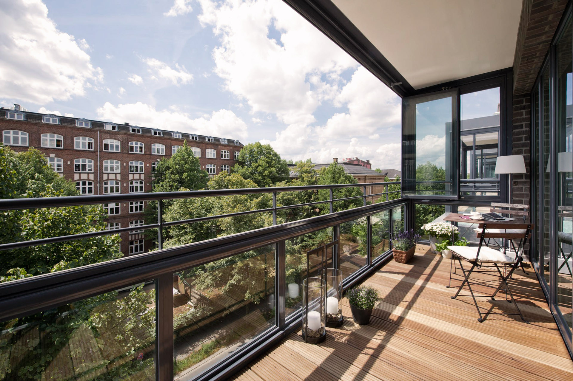balcony with outdoor furniture glass doors and urban views