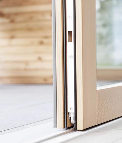 Close up of a wooden sliding door on it's track