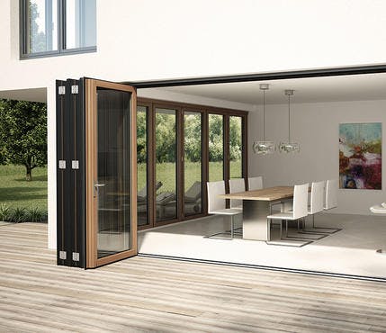A modern home with bi-folding doors on two walls letting in lots of natural light