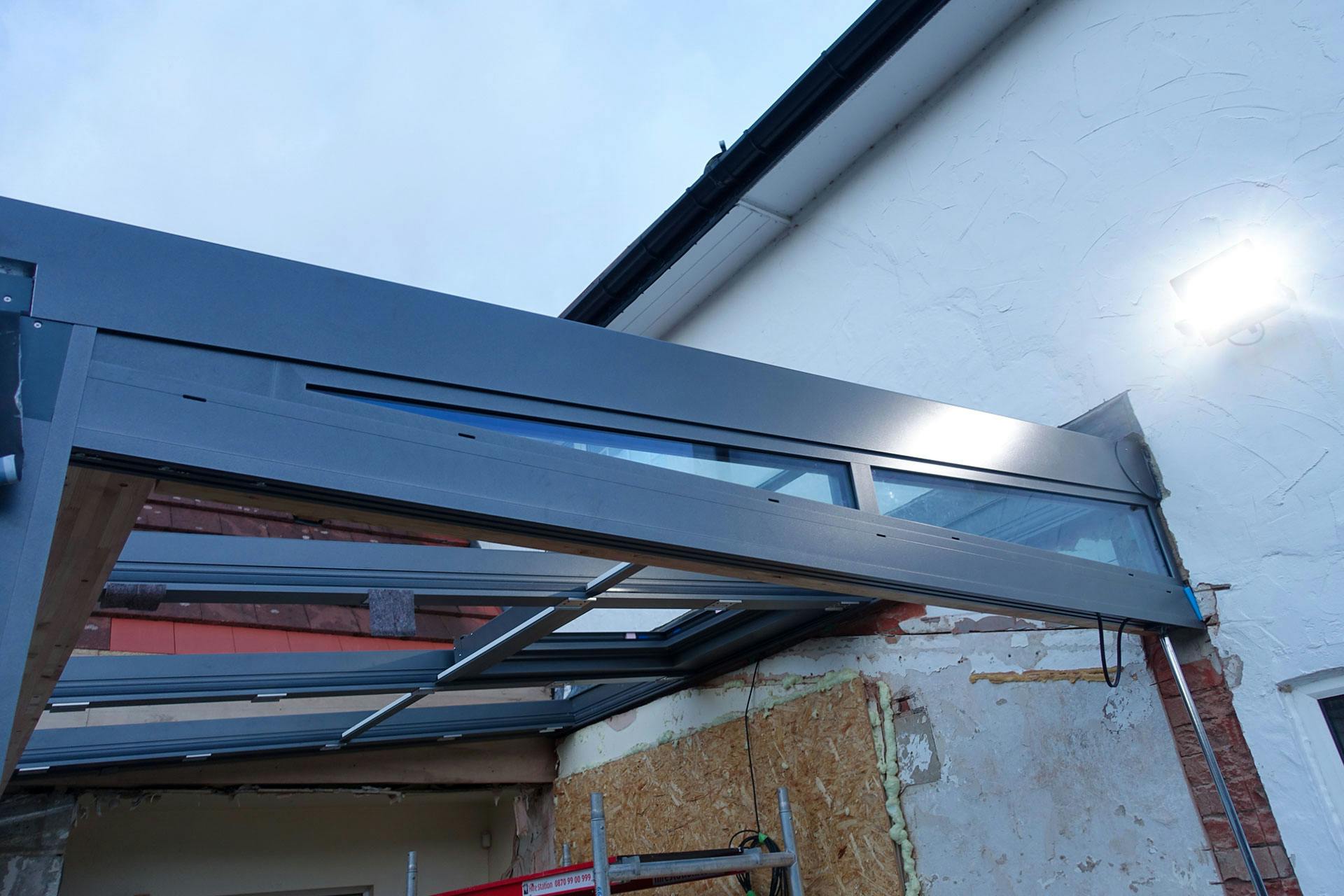 glass extension fixings on wall of house