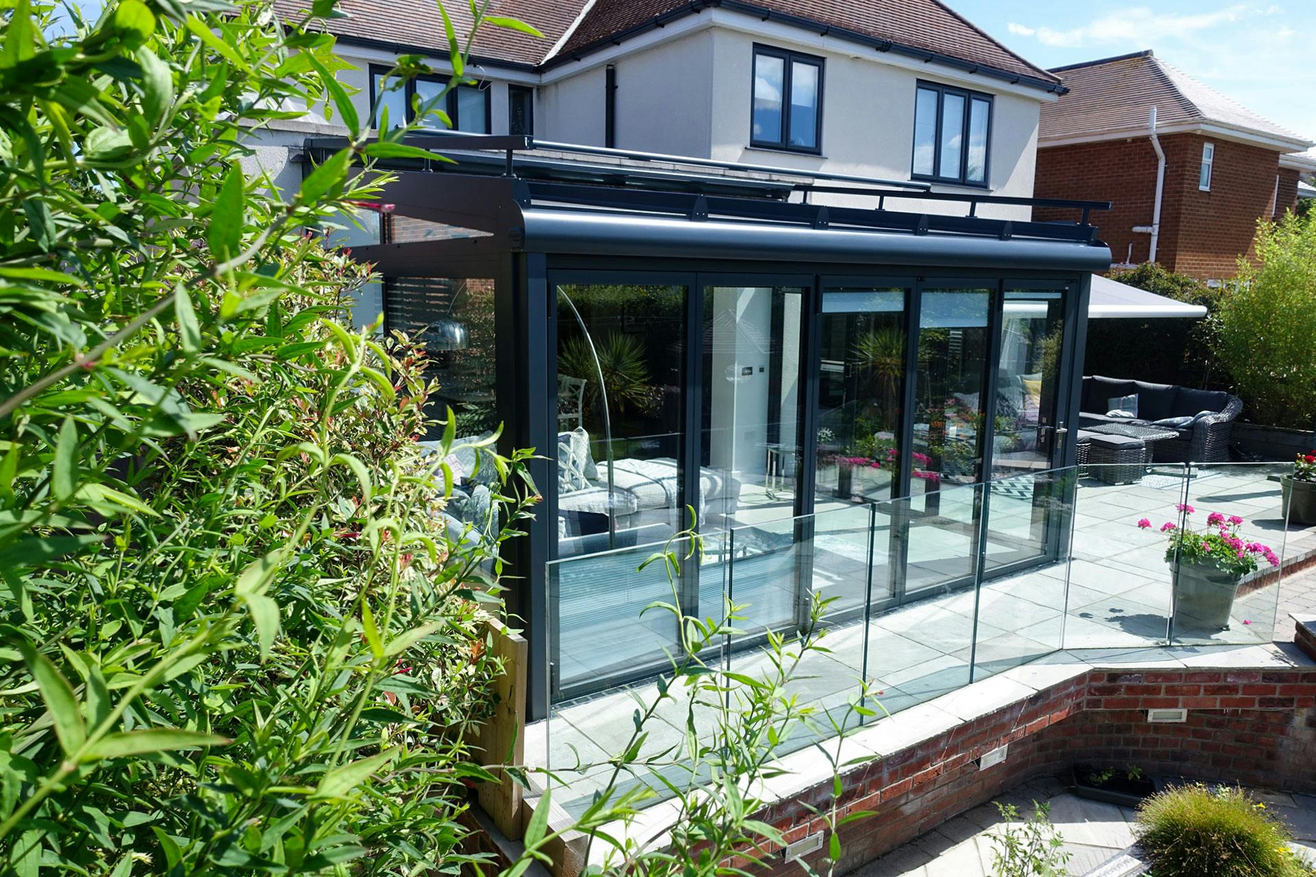 Glass garden room extension on coastal property