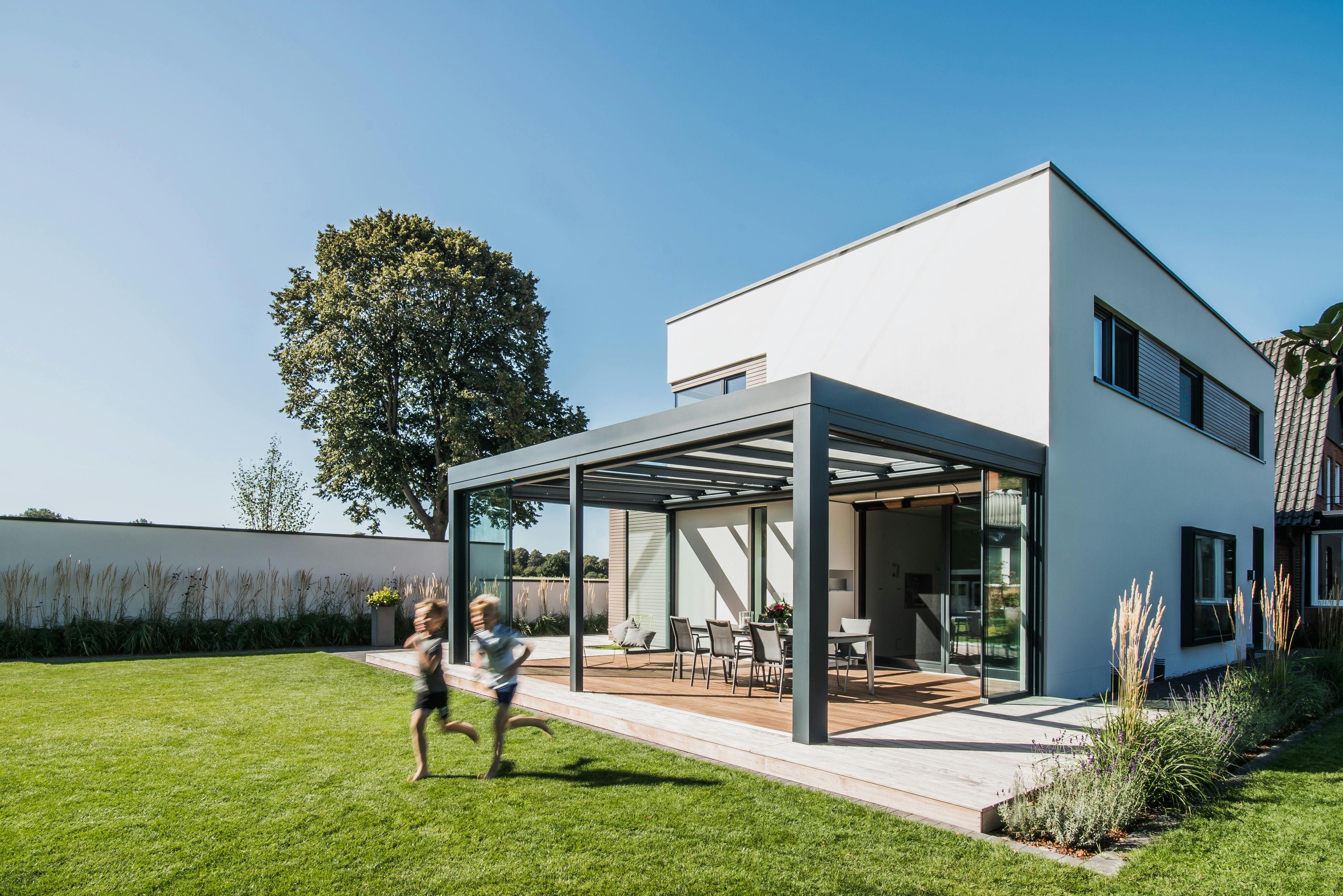 white modern cube shaped house with aluminium and glass extension