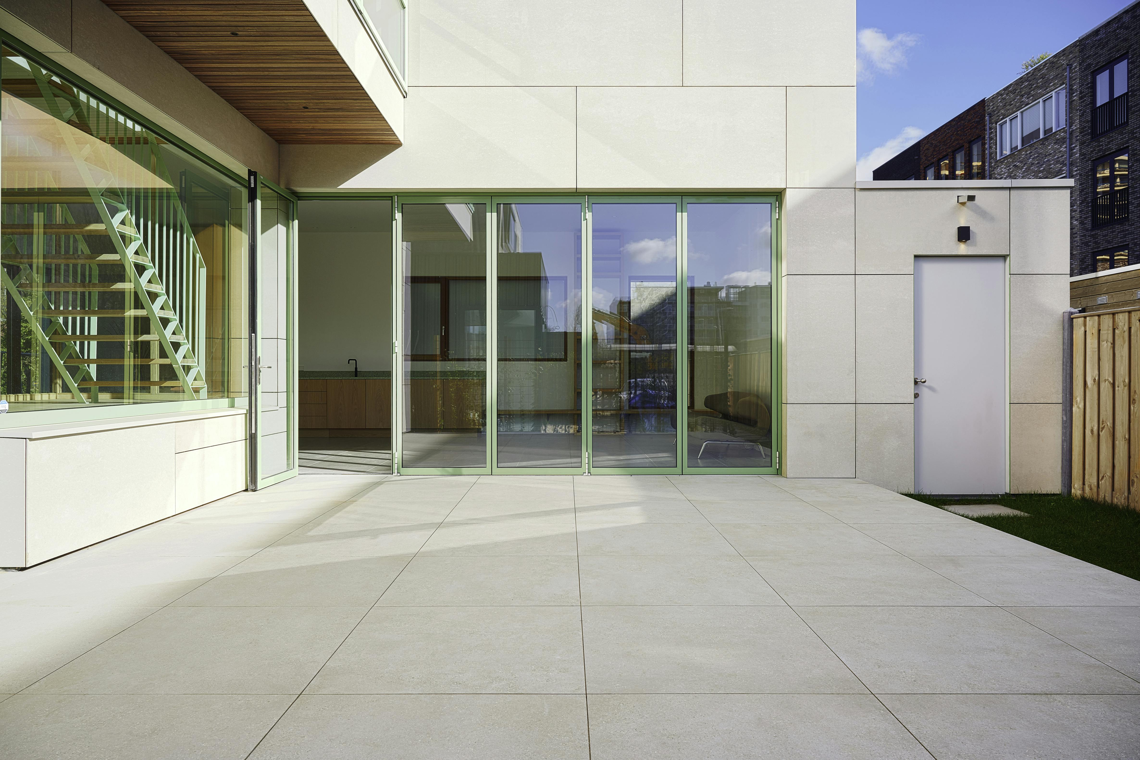 Closed bi-folding doors with access leaf / traffic door on the left