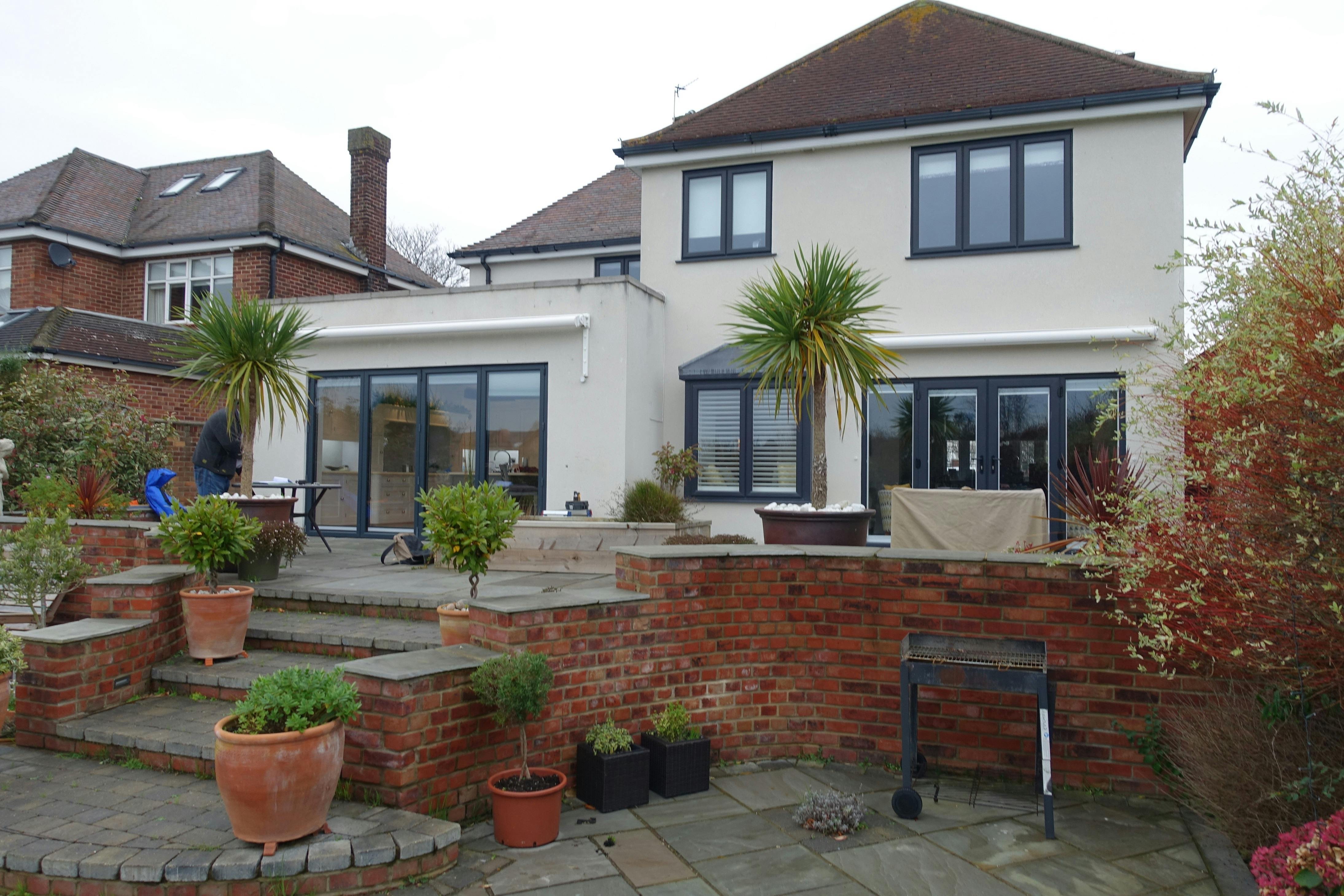 Before a glass garden room extension