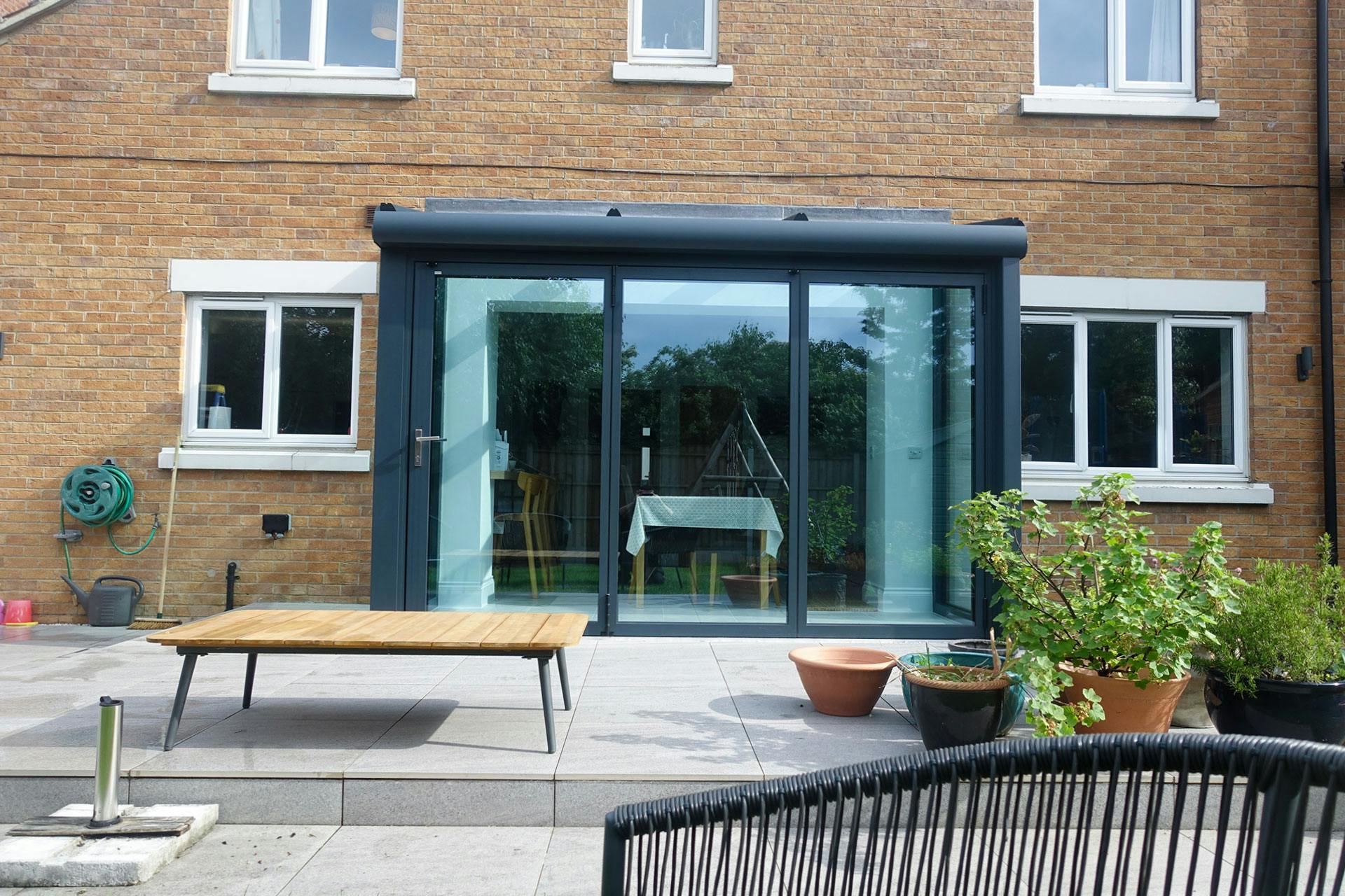 small glass extension on modest home