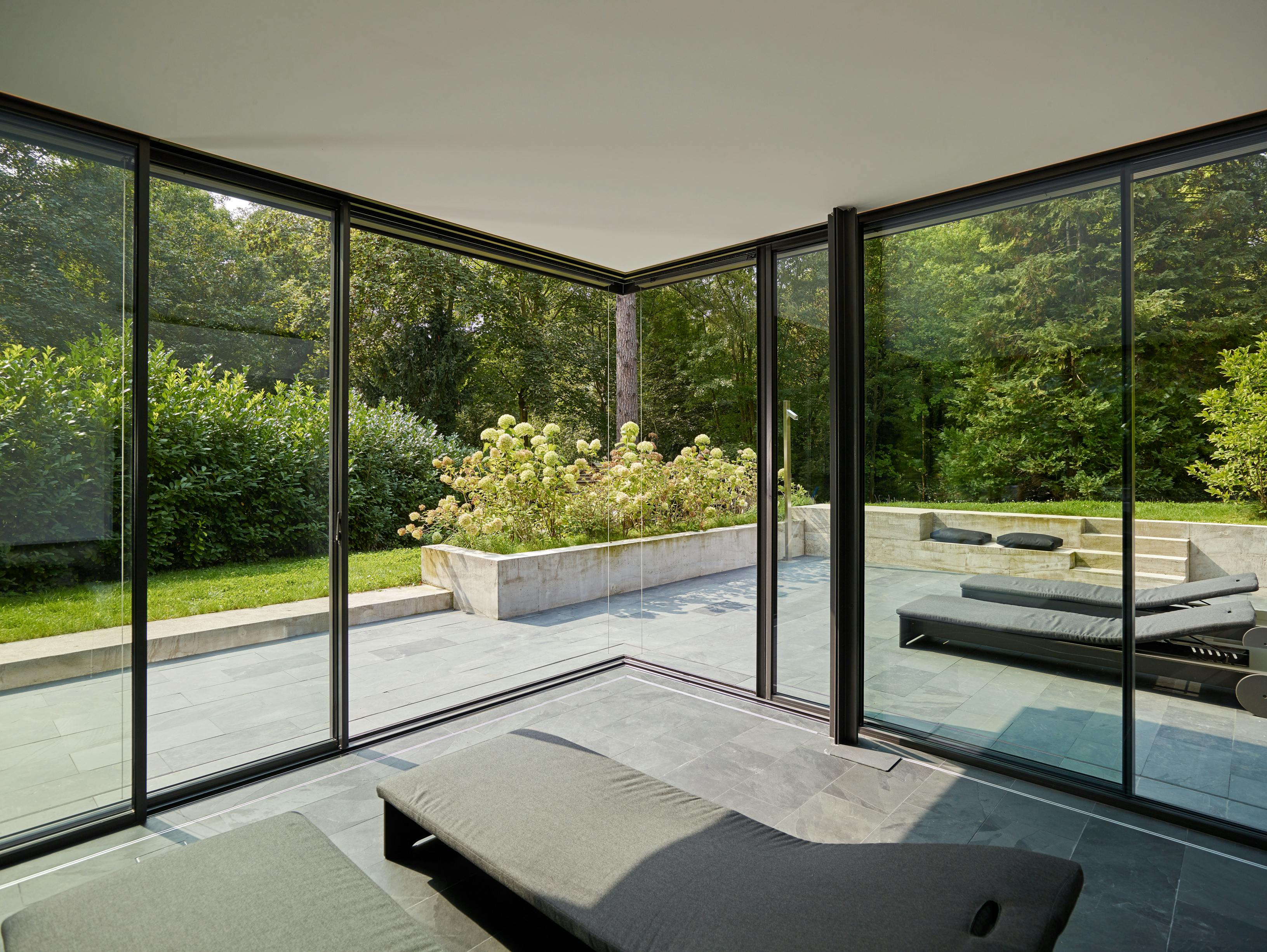 spa room with large glass sliding doors meeting at a corner