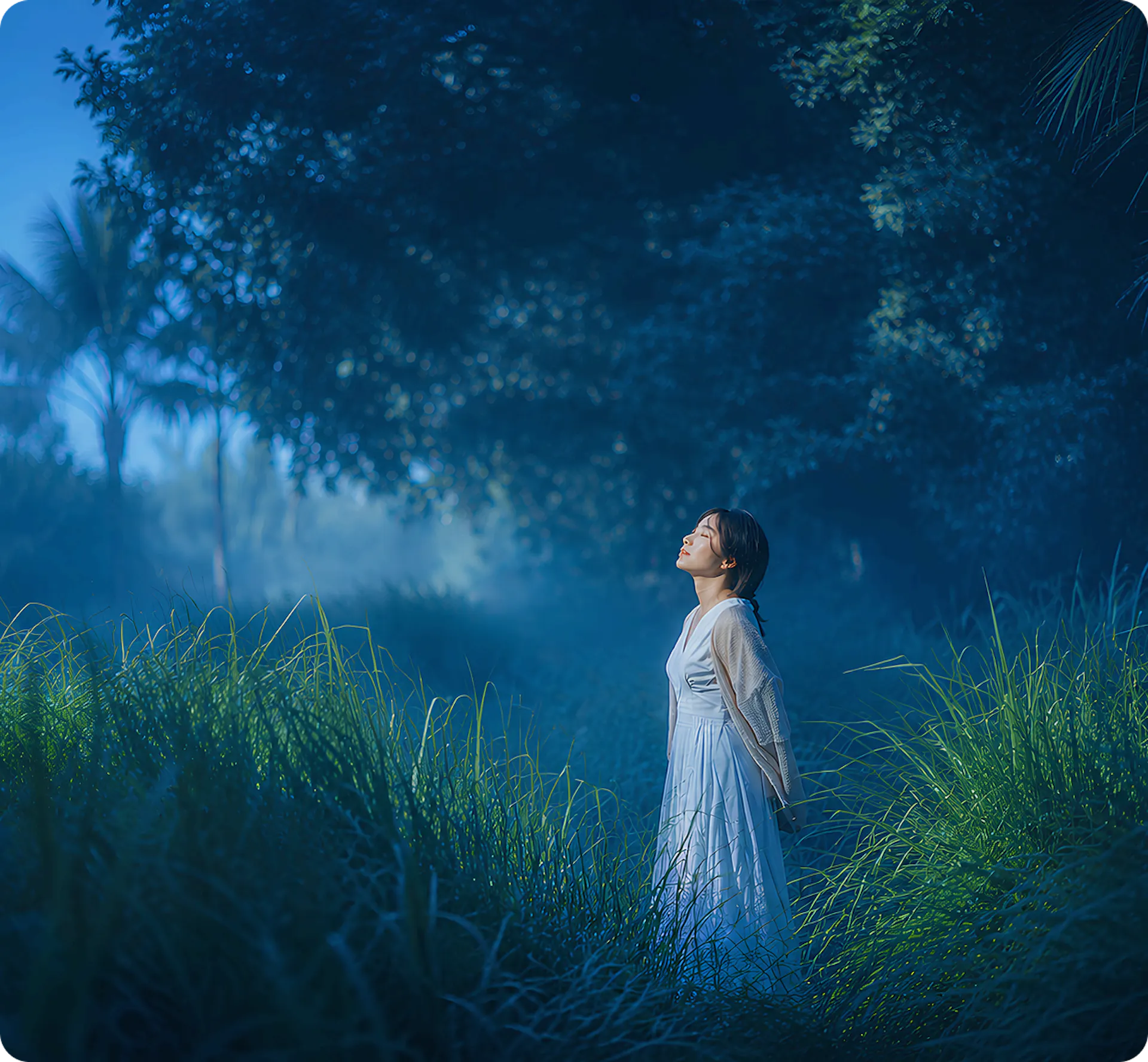 woman with eyes closed standing in a field