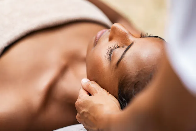 A lady receiving a spa treatment while laying down