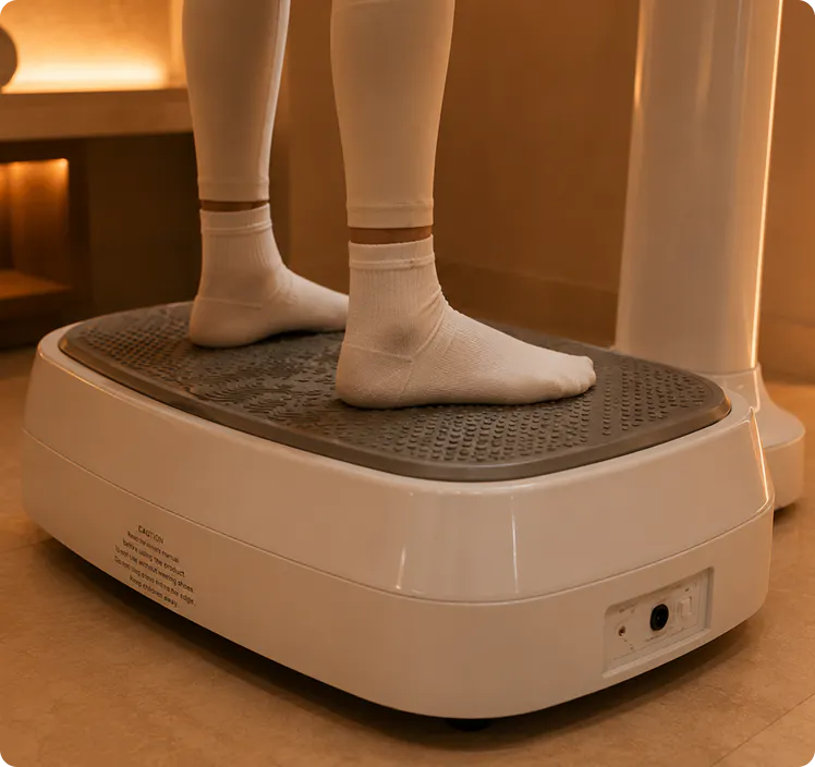 Two feet standing on a vibrating machine
