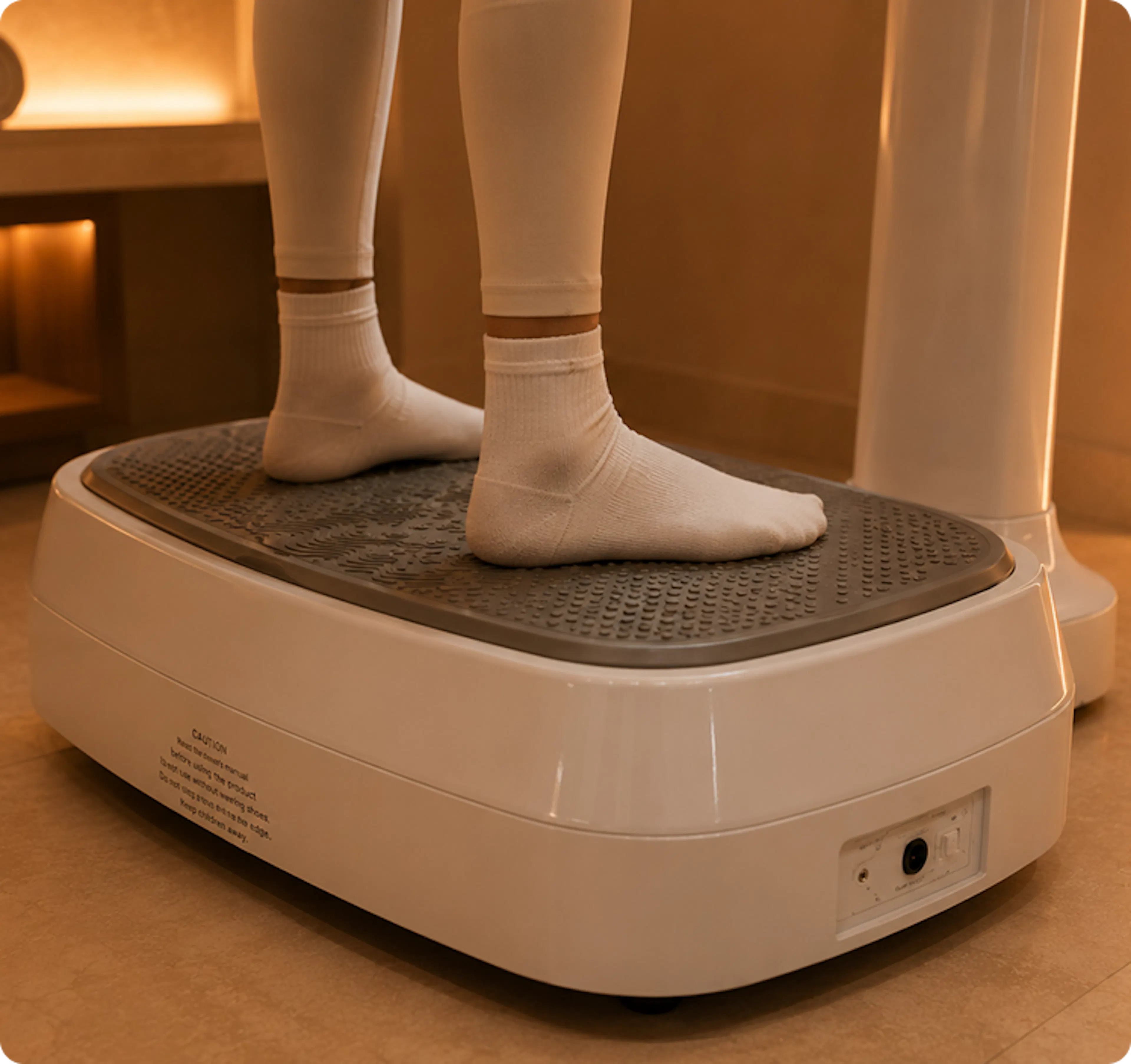 Two feet standing on a vibrating machine