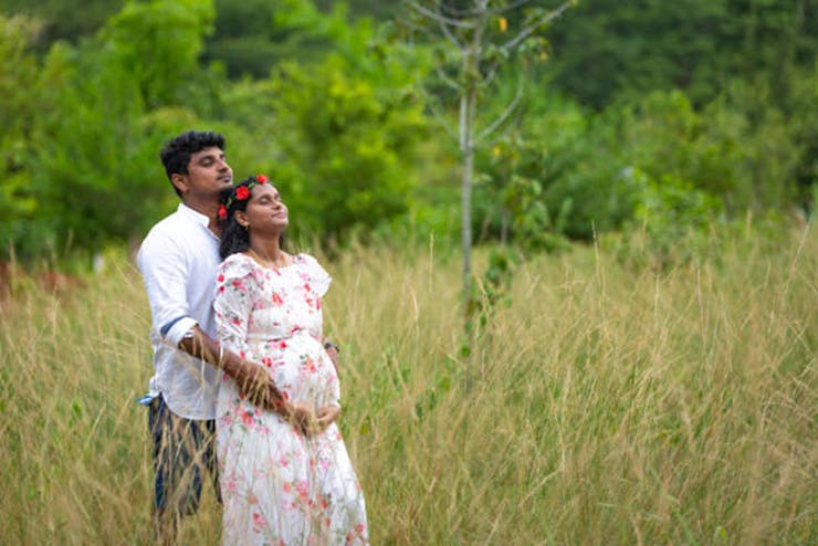 A Pregnant Indian Lady Poses for Outdoor Pregnancy Shoot and Hands