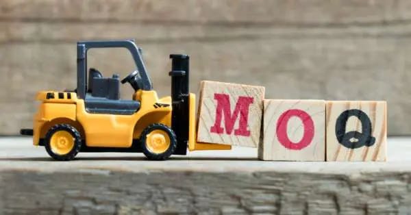 Image of a toy truck in front of wooden blocks spelling MOQ