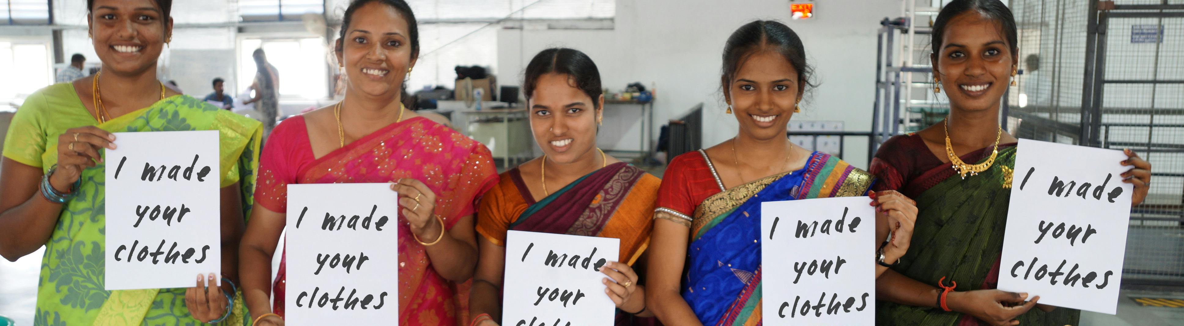 Five people smiling hold a sign saying "I made your clothes"