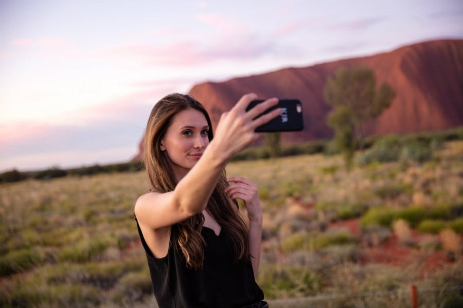 Person taking a photo at Uluru