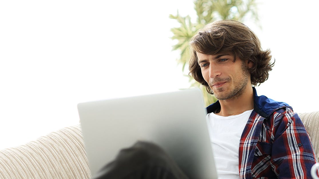 Young man looking at laptop