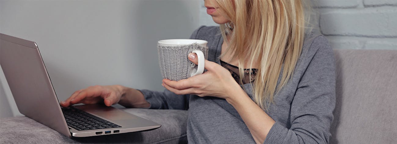 Young woman using laptop on couch
