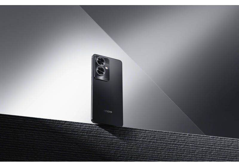 A black OPPO A79 5G handset on a black grey and white textured background. 
