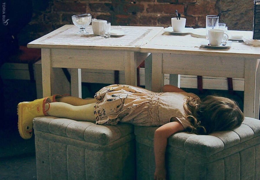 Kid laying on chairs