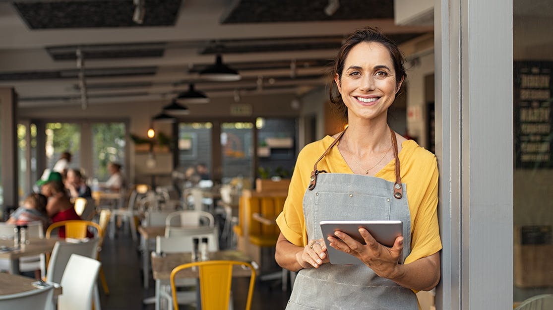 Lady with a tablet at her cafe