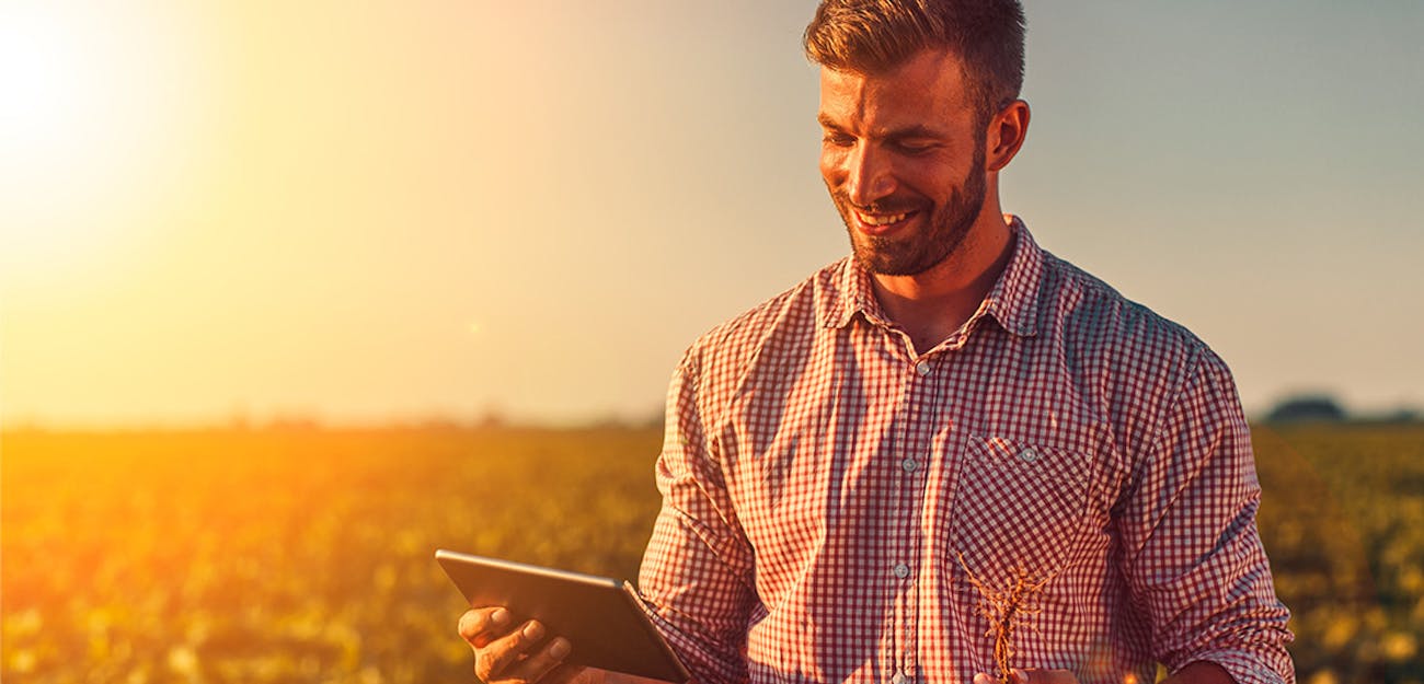 man in field with tablet