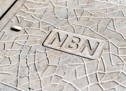 nbn font on man hole which holds fibre optic cable.