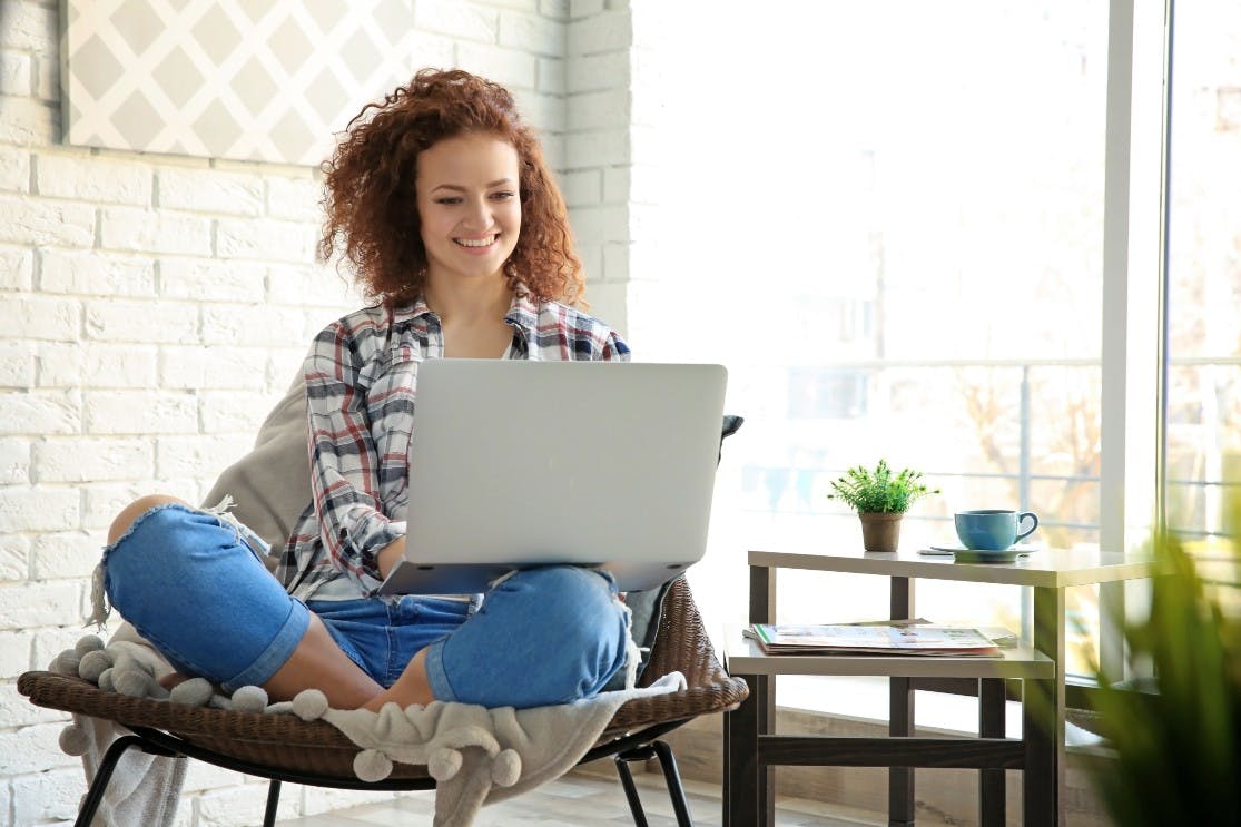 Young woman looking at her laptop