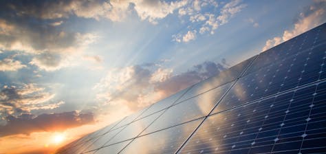 Solar panels with sun setting
