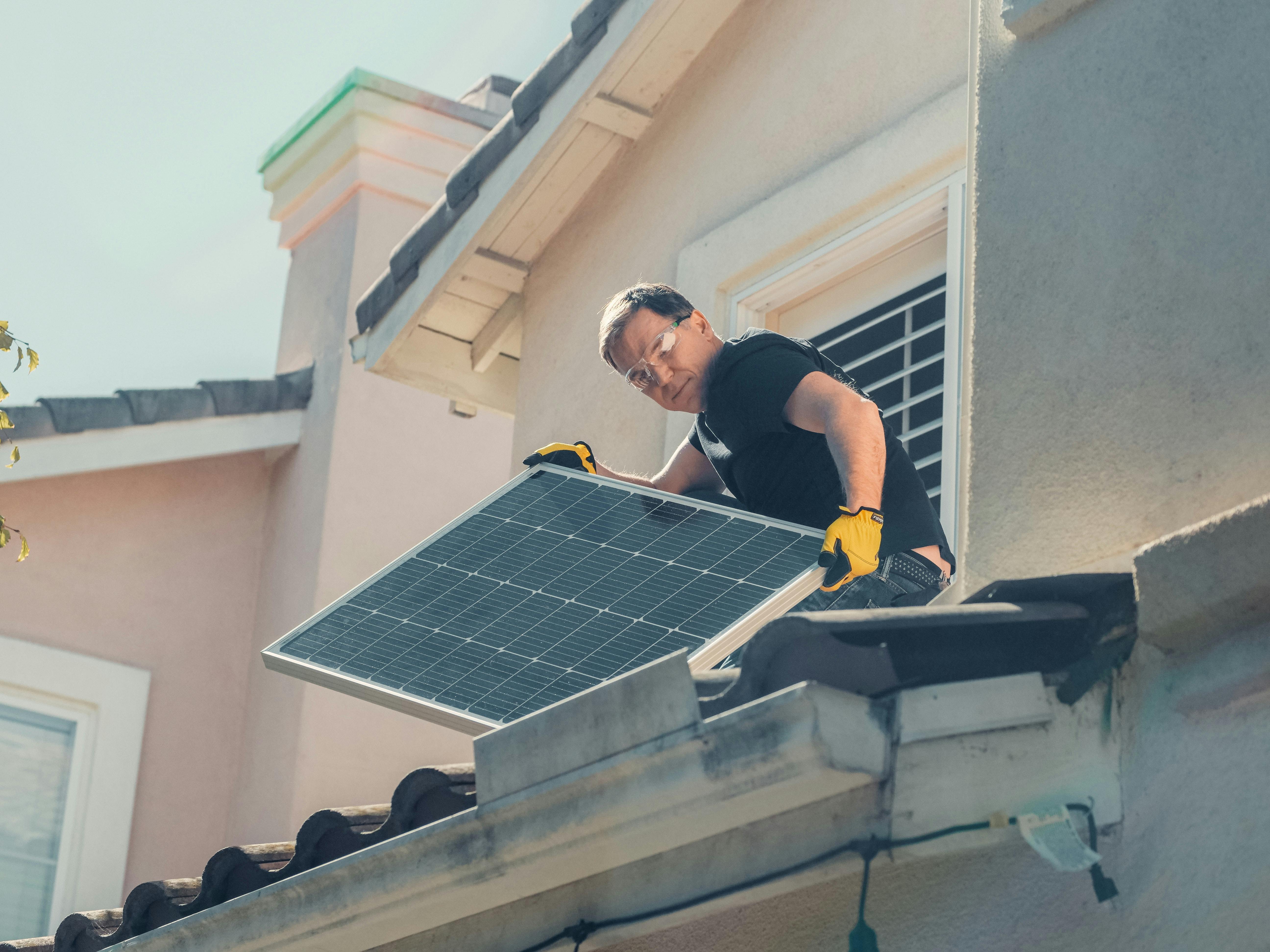 man installing solar panels