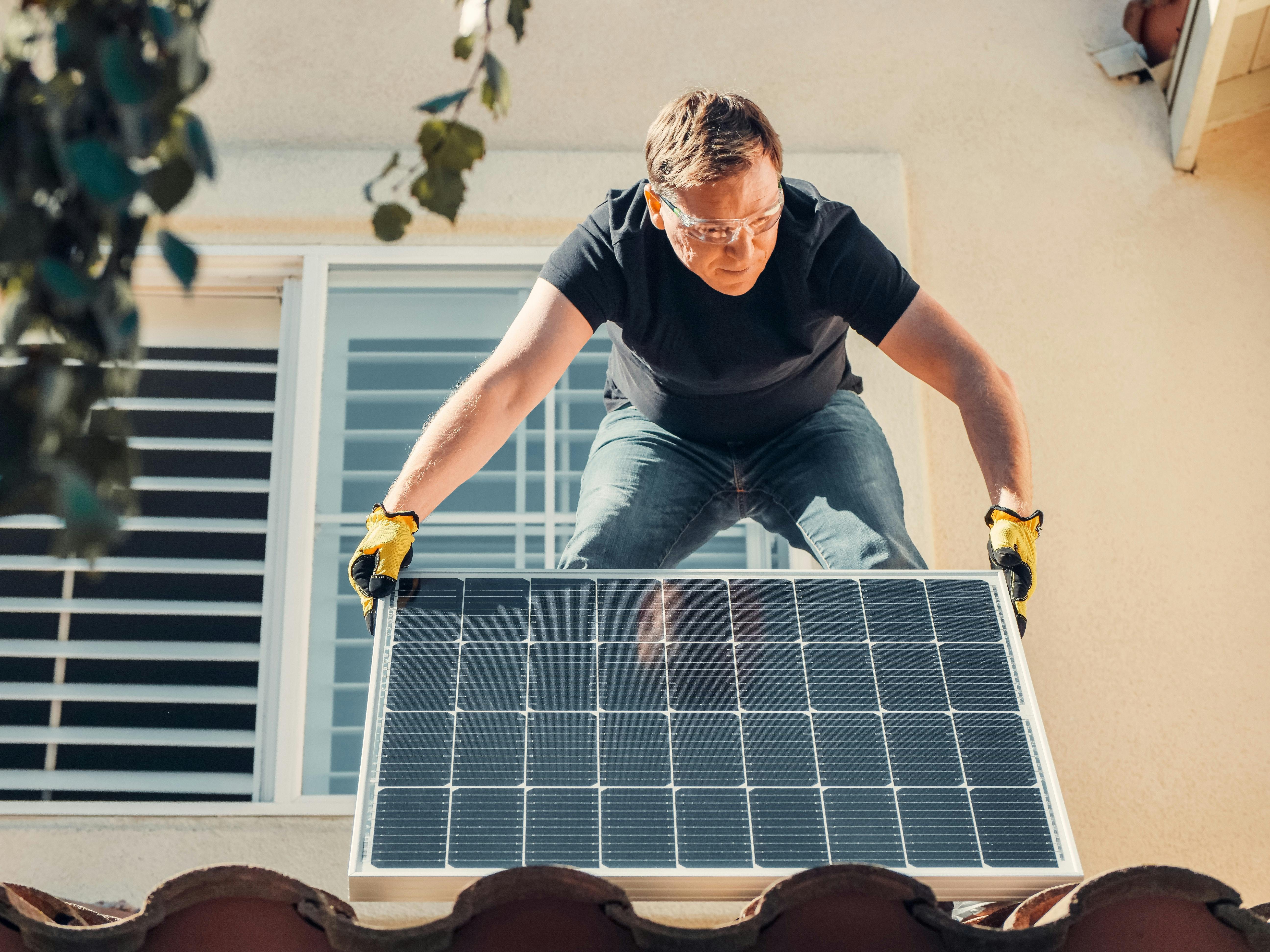 man installing solar panel