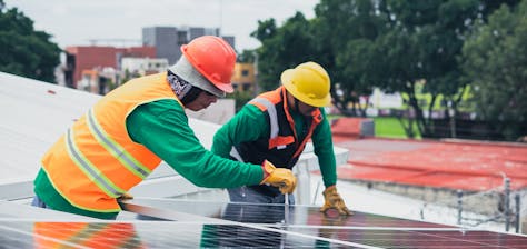 Solar panel experts installing a solar panel