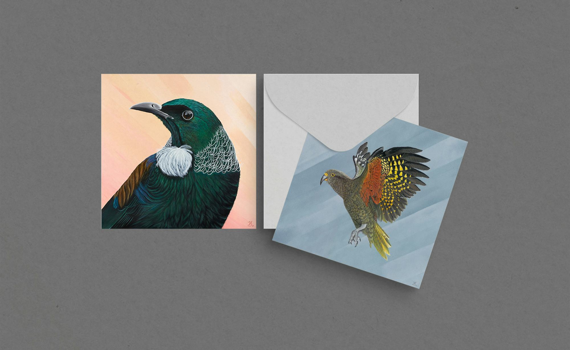 Beautiful greeting cards with a kea bird taking flight and a tui on an abstract background.
