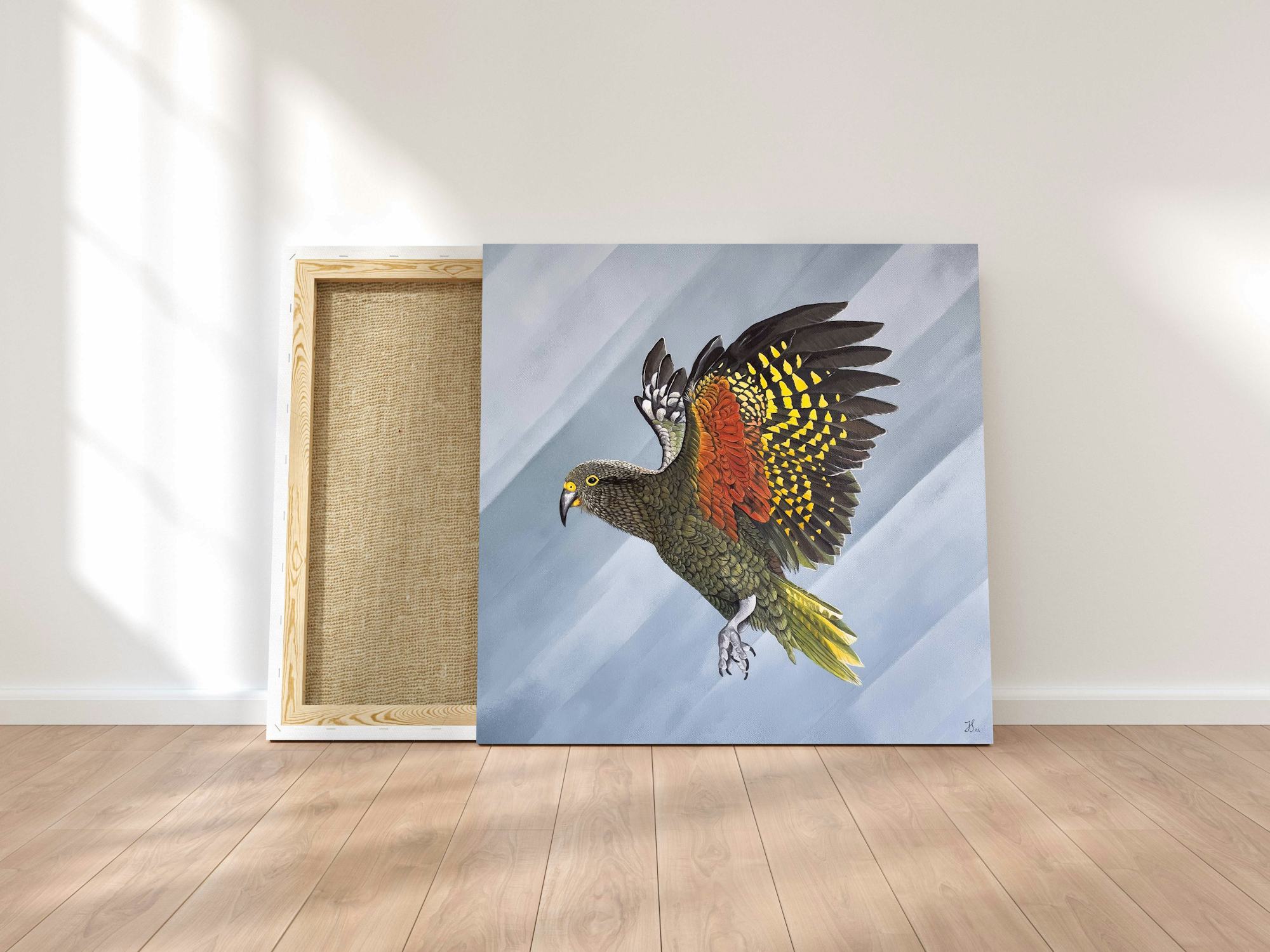 Painting of a NZ native Kea bird on canvas, leaned against a wall.