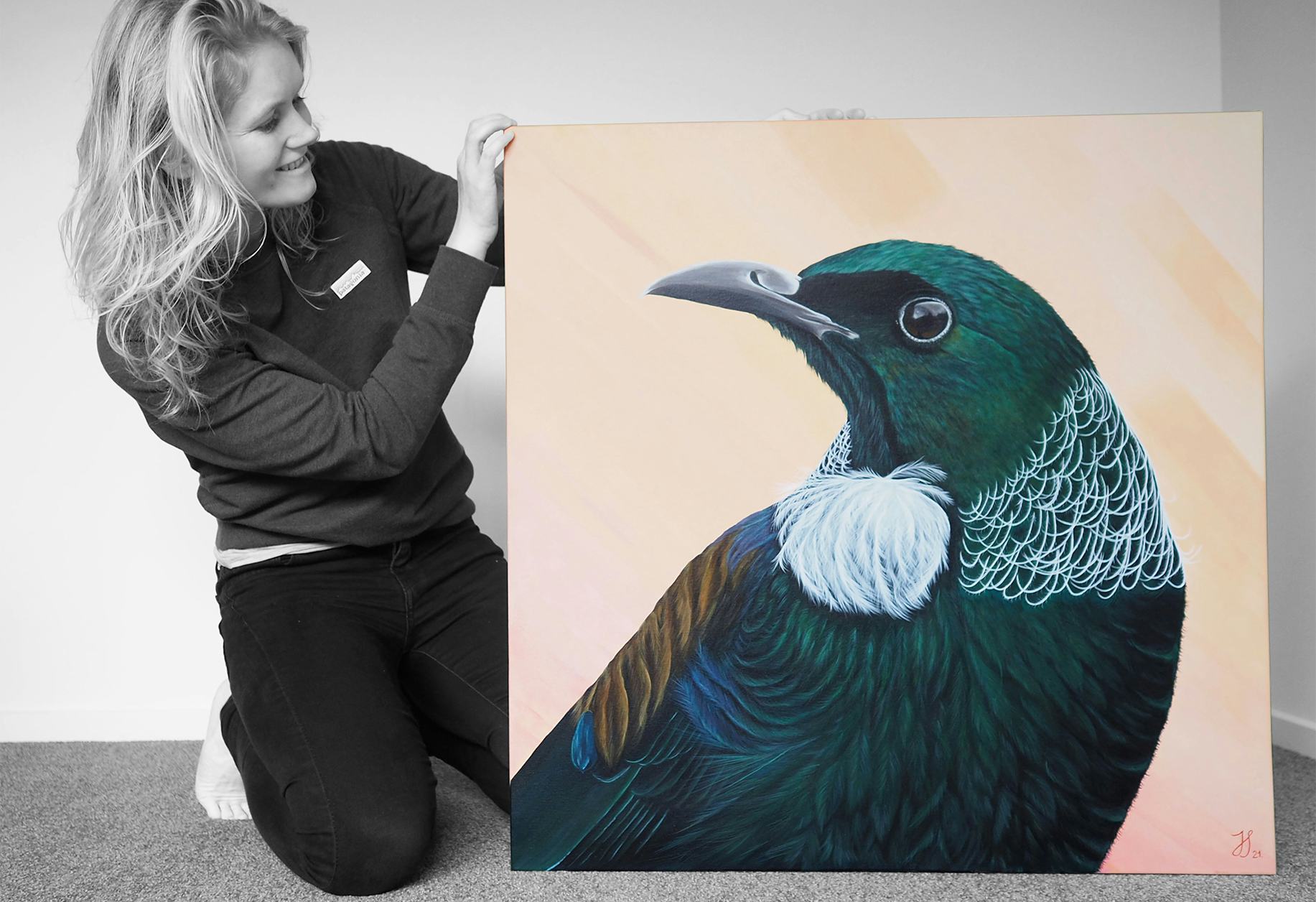 Artist, Johanna Seibel showcasing her acrylic on canvas painting of a NZ native tui bird.