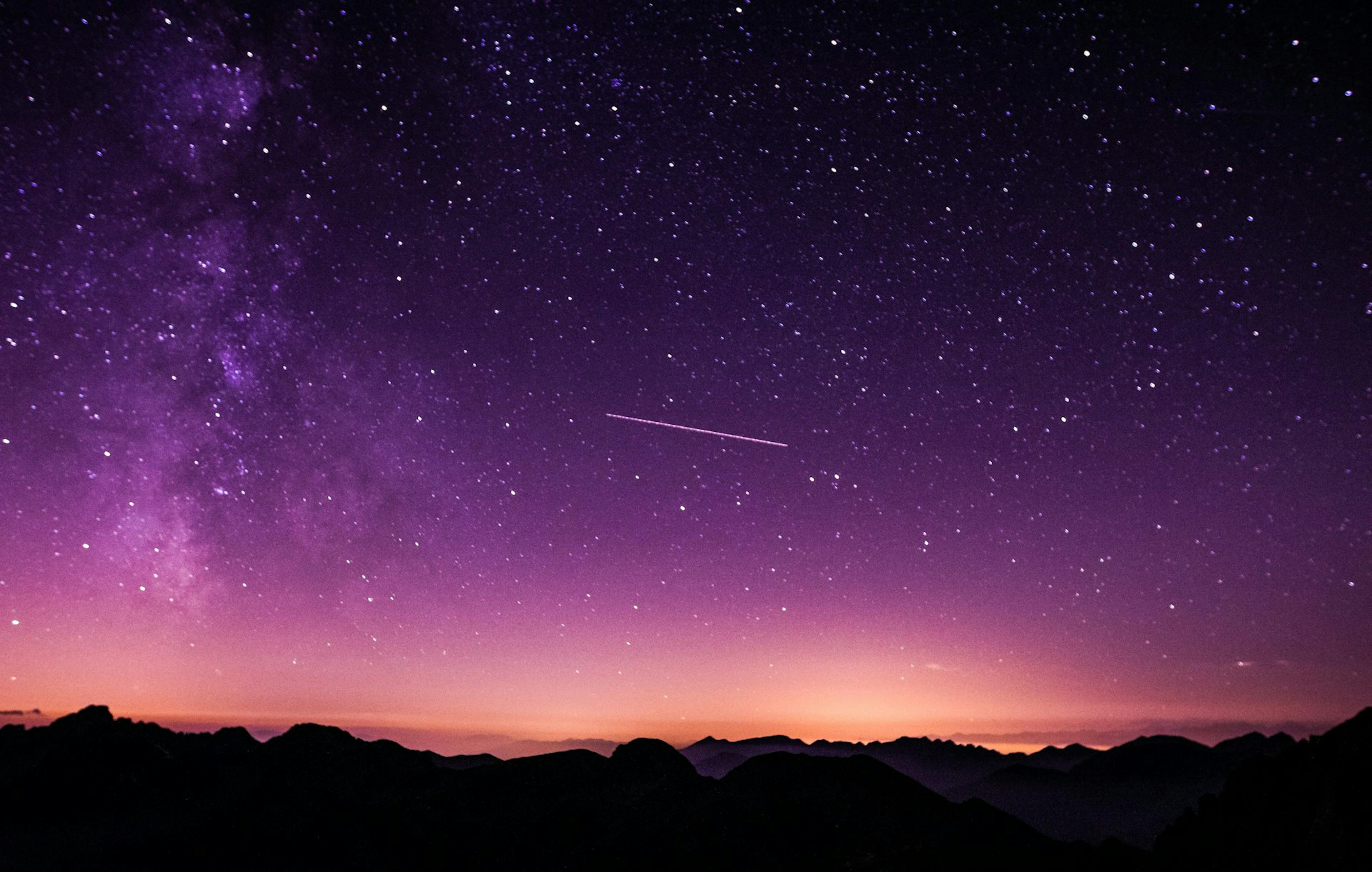 Purple and pink night sky with mountains