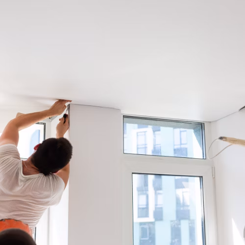 Ein Mann montiert eine Spanndecke - Spanndecken Markowski GmbH