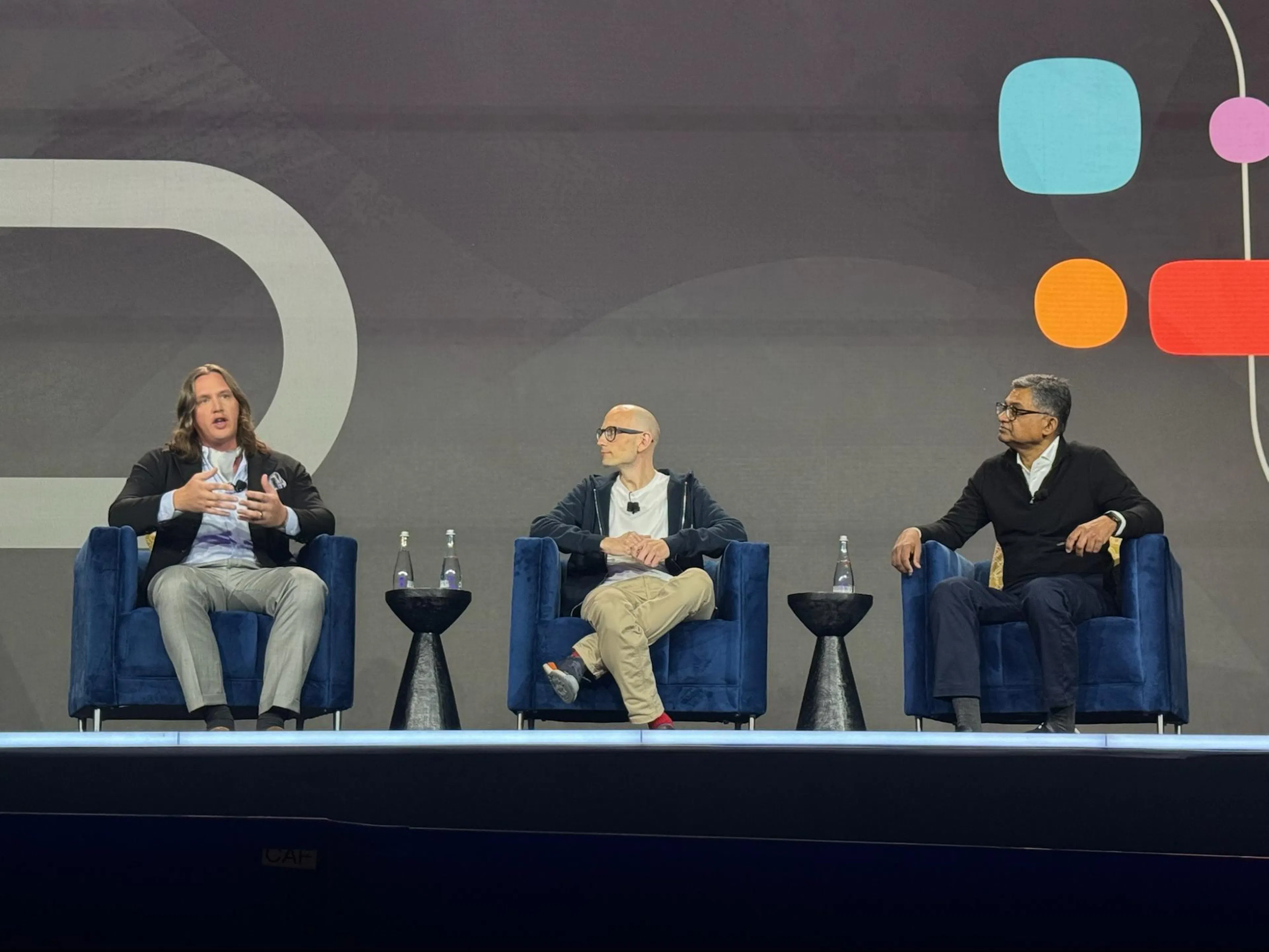 Christian Grupp, founder and CEO of Sphere, speaking on stage at Oracle AI World 2025 alongside Hasan Rizvi of Oracle and a fellow panelist