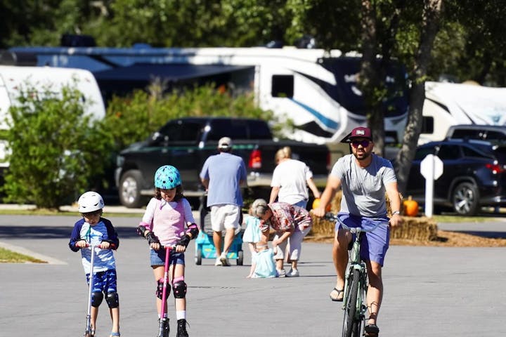 Families Enjoying Scooters and Bikes at Splash RV Resort