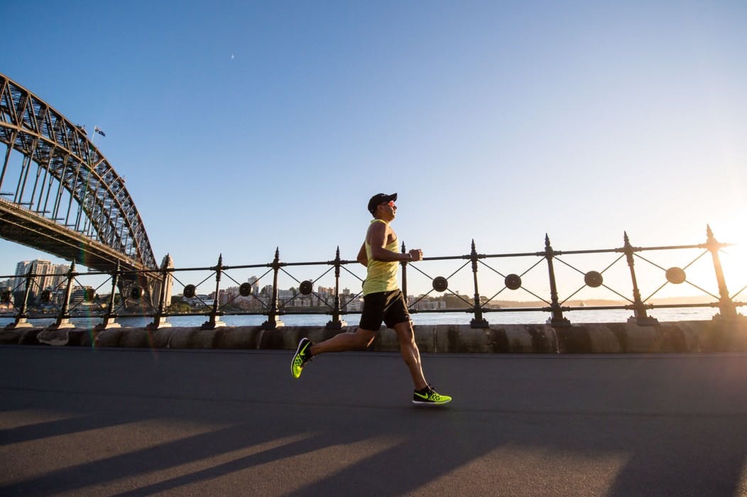 Man running on the bridge at daylight